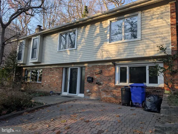 a view of a brick house with large windows