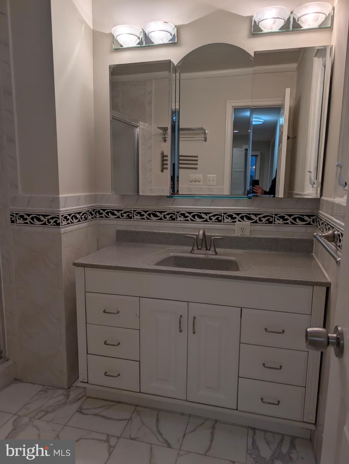 6705 Goldsboro Road Bethesda, MD 20817 - Photo 35 of 60 a bathroom with a sink and a mirror