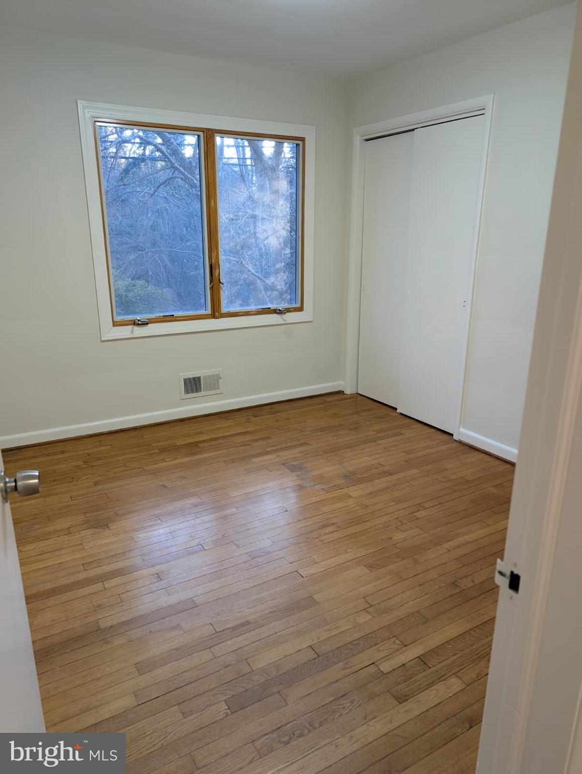 6705 Goldsboro Road Bethesda, MD 20817 - Photo 40 of 60 an empty room with wooden floor and windows
