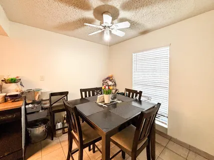 a view of a dining room with furniture and chandelier