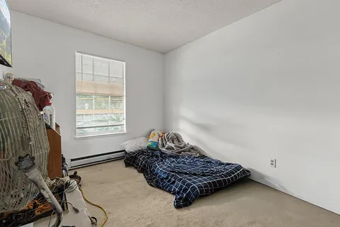 a room with a bed and a window