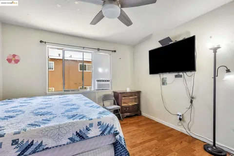 a bedroom with a bed and a flat screen tv