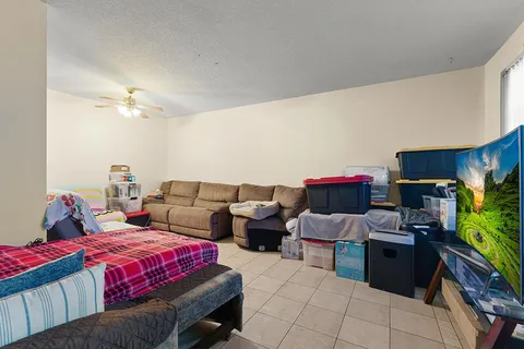 a bedroom with bed and a chandelier