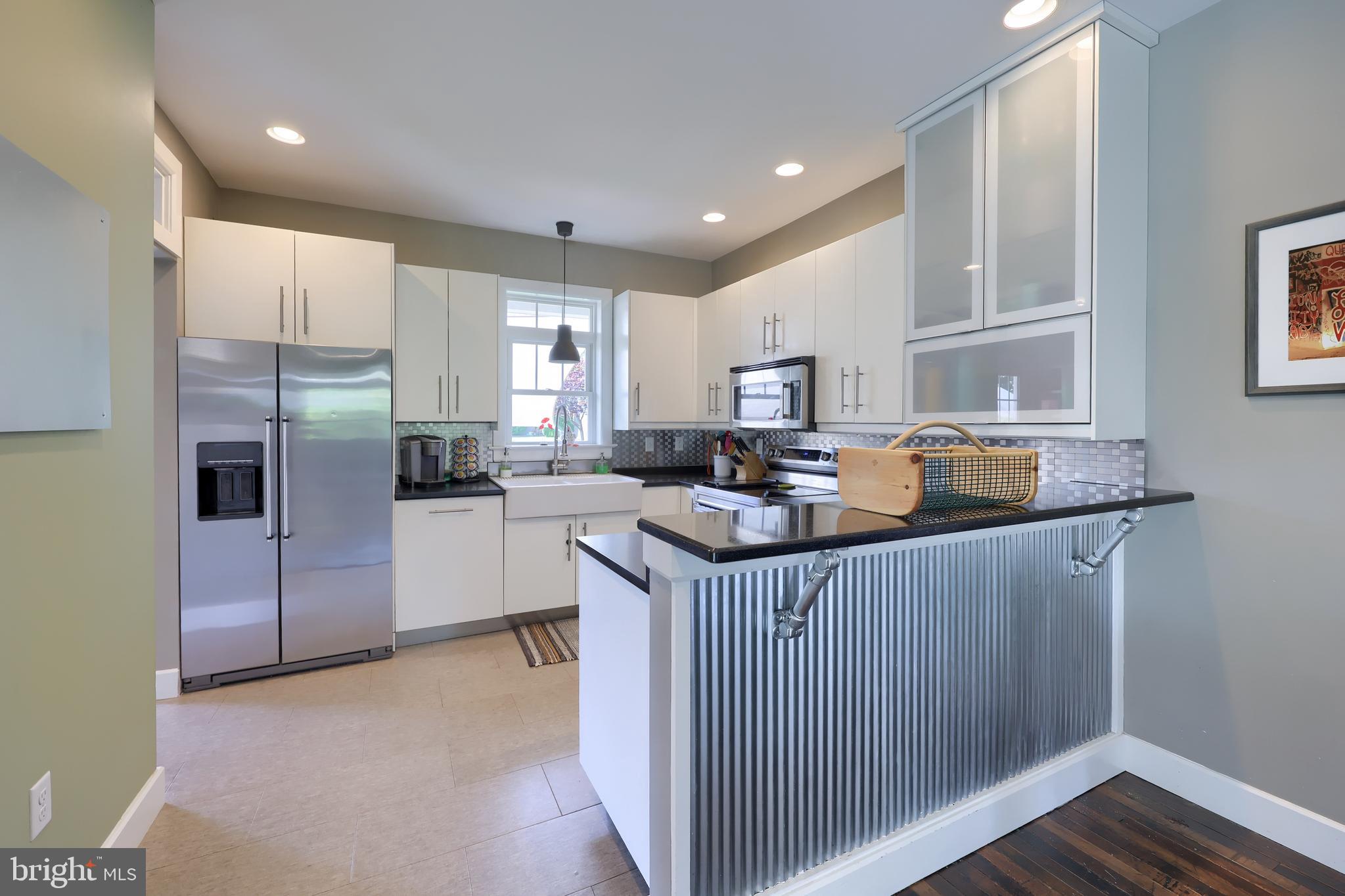356 North Broad Street Lititz, PA 17543 - Photo 12 of 53 a kitchen with kitchen island granite countertop a sink refrigerator and microwave