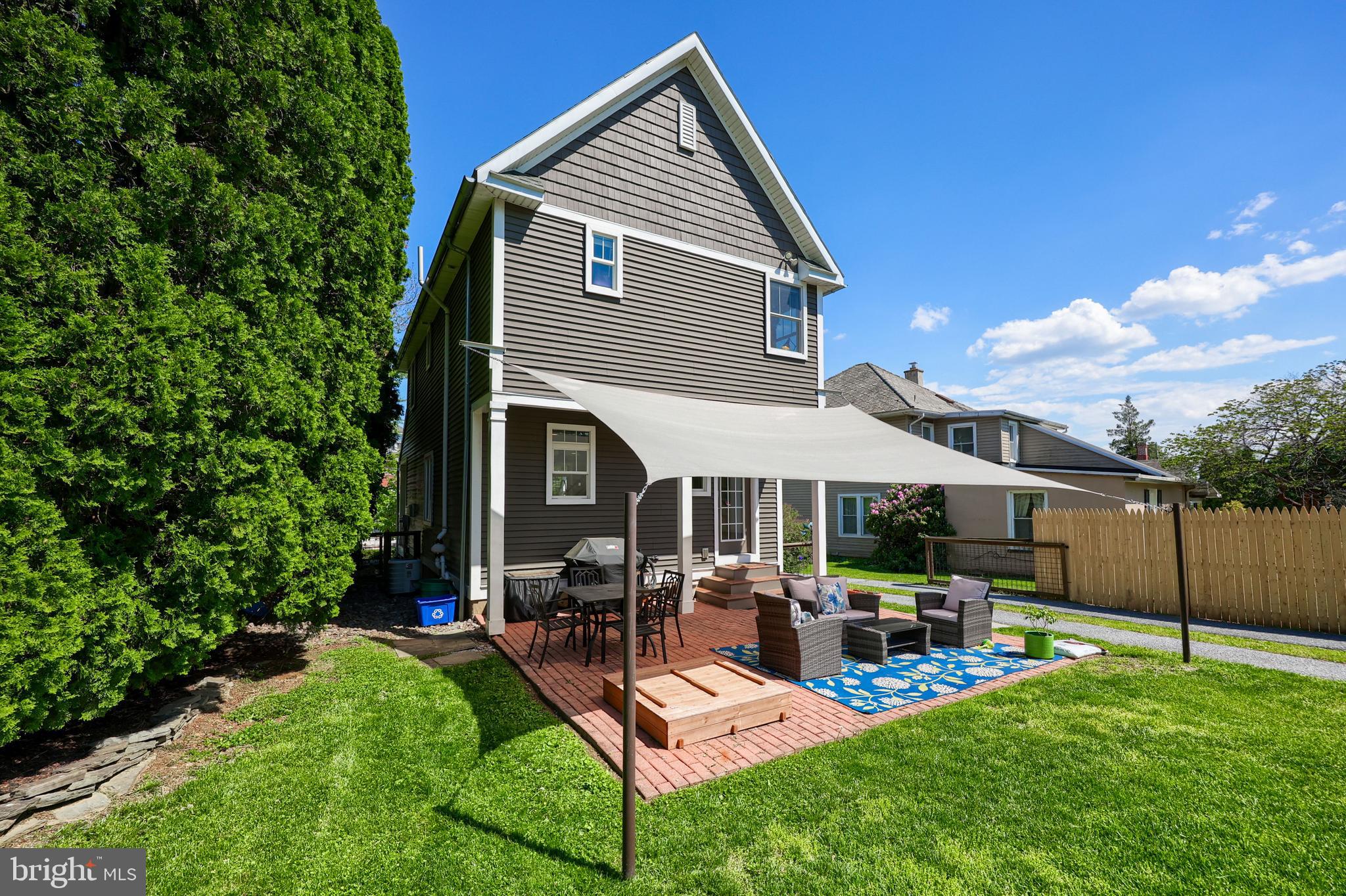 356 North Broad Street Lititz, PA 17543 - Photo 40 of 53 a view of a patio with table and chairs potted plants and a palm tree