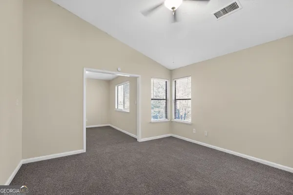an empty room with windows and entrance