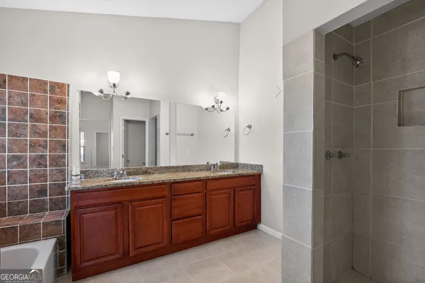a bathroom with a double vanity sink and a mirror