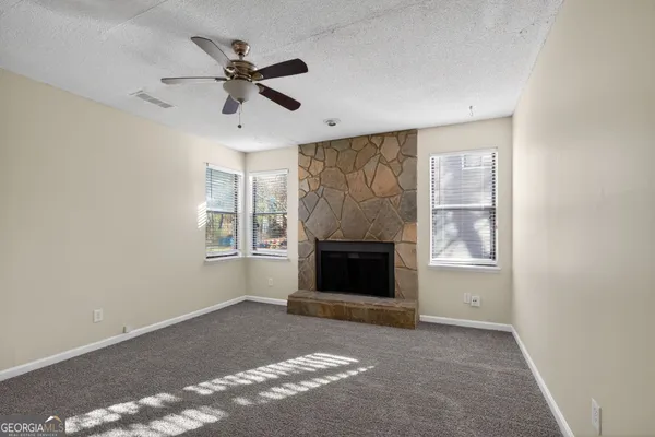 a living room with a fireplace and a window