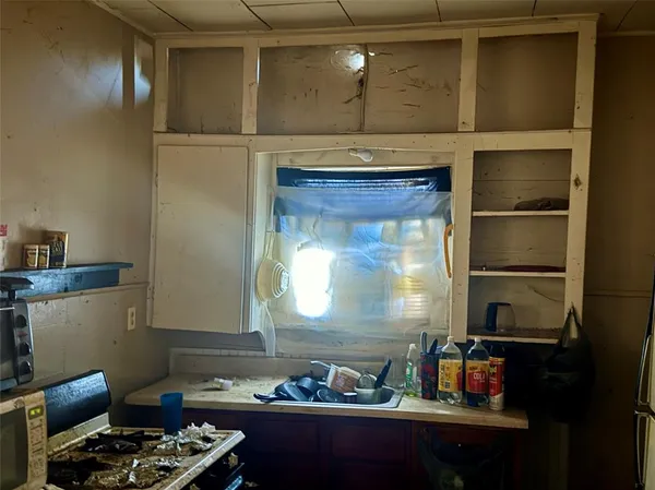 a kitchen with a refrigerator and a stove