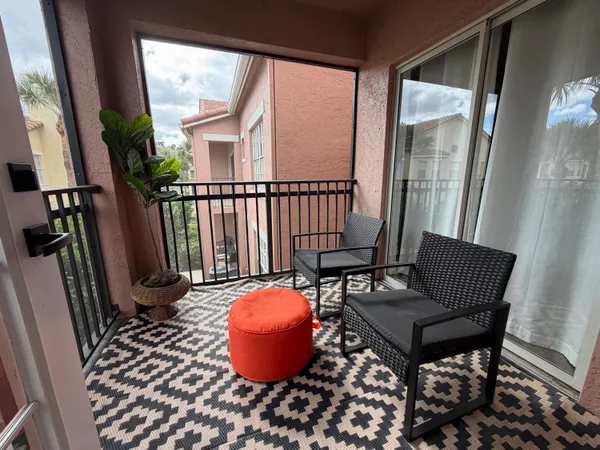 a view of a porch with furniture and a window