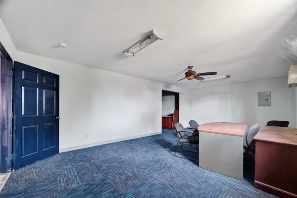 a view of a workspace with furniture and a window