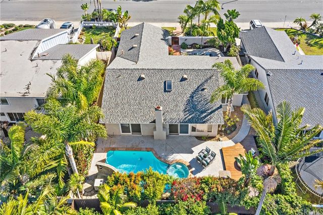 a view of swimming pool with outdoor seating and plants