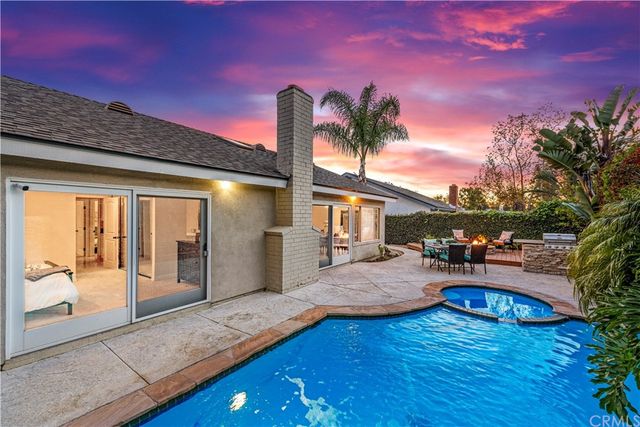 a view of a patio with couches table and chairs and potted plants