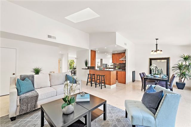 a view of a dining room with furniture and a chandelier
