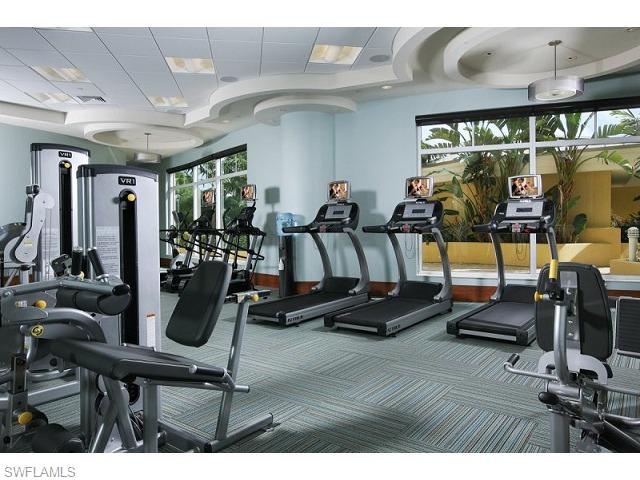 13675 Vanderbilt Drive, Unit 1107 Naples, FL 34110 - Photo 14 of 23 a view of a room with gym equipment