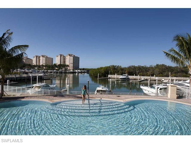 13675 Vanderbilt Drive, Unit 1107 Naples, FL 34110 - Photo 17 of 23 a swimming pool view with a lake view
