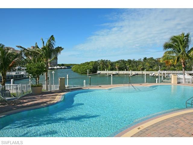 13675 Vanderbilt Drive, Unit 1107 Naples, FL 34110 - Photo 18 of 23 a view of a backyard