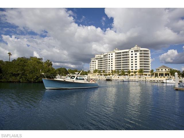 13675 Vanderbilt Drive, Unit 1107 Naples, FL 34110 - Photo 19 of 23 a view of a lake with tall buildings