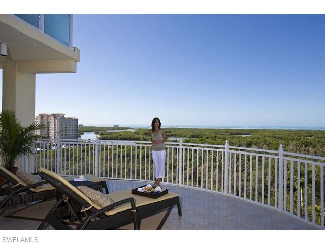 13675 Vanderbilt Drive, Unit 1107 Naples, FL 34110 - Photo 21 of 23 a view of a balcony with wooden floor