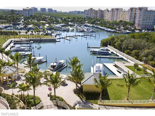 13675 Vanderbilt Drive, Unit 1107 Naples, FL 34110 - Photo 4 of 23 a view of a lake with a city