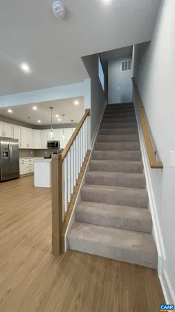 a view of entryway and hall with wooden floor