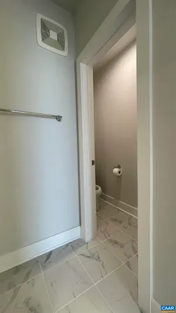 a view of a hallway with wooden floor and entryway