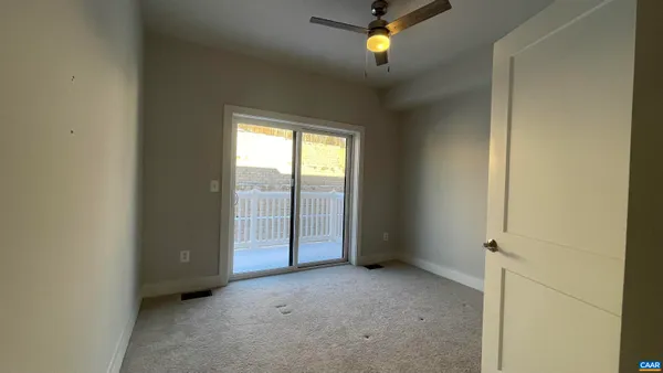 an empty room that has a mirror in it