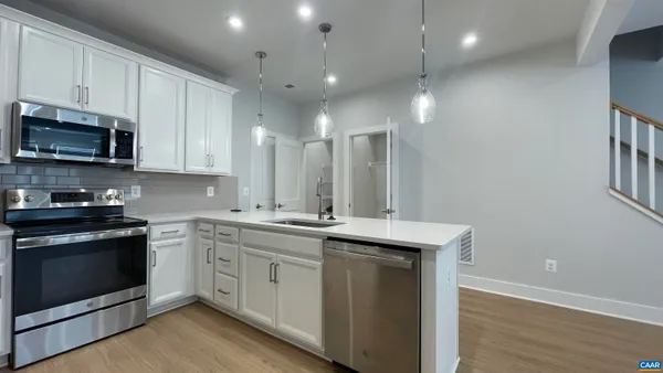 a kitchen with a sink stove and microwave
