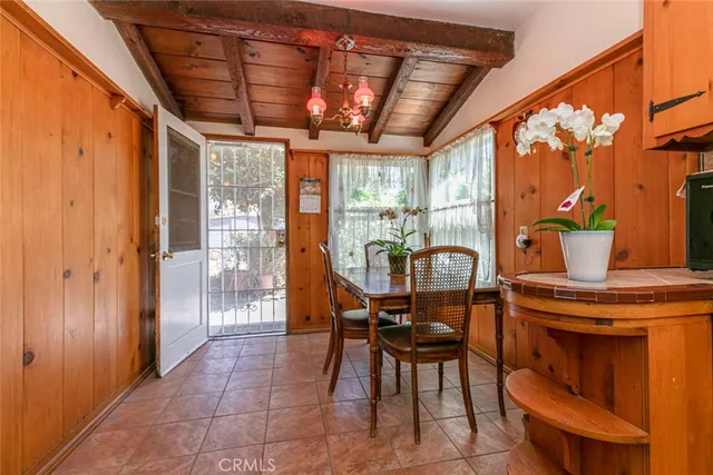 a dining room with furniture a chandelier and wooden floor