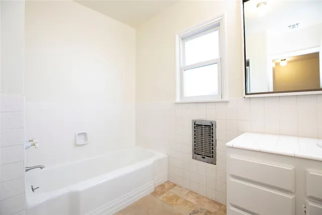 a bathroom with a bathtub and a sink