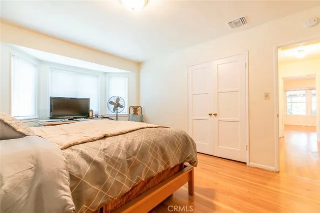 a bedroom with a bed and a tv