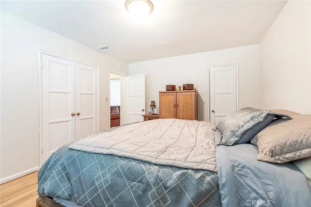 a bedroom with a bed and a closet