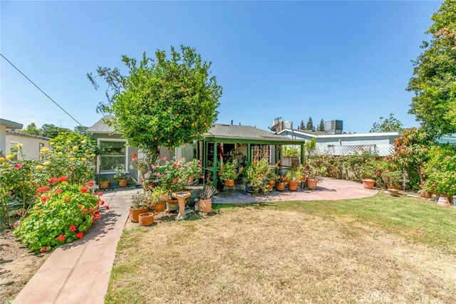 a view of a house with swimming pool and sitting area