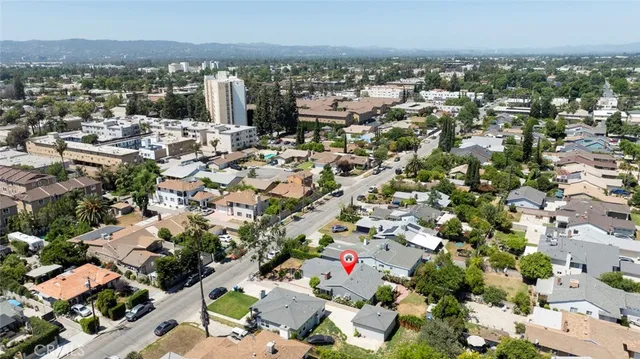 a view of a house with wooden walls and potted plants