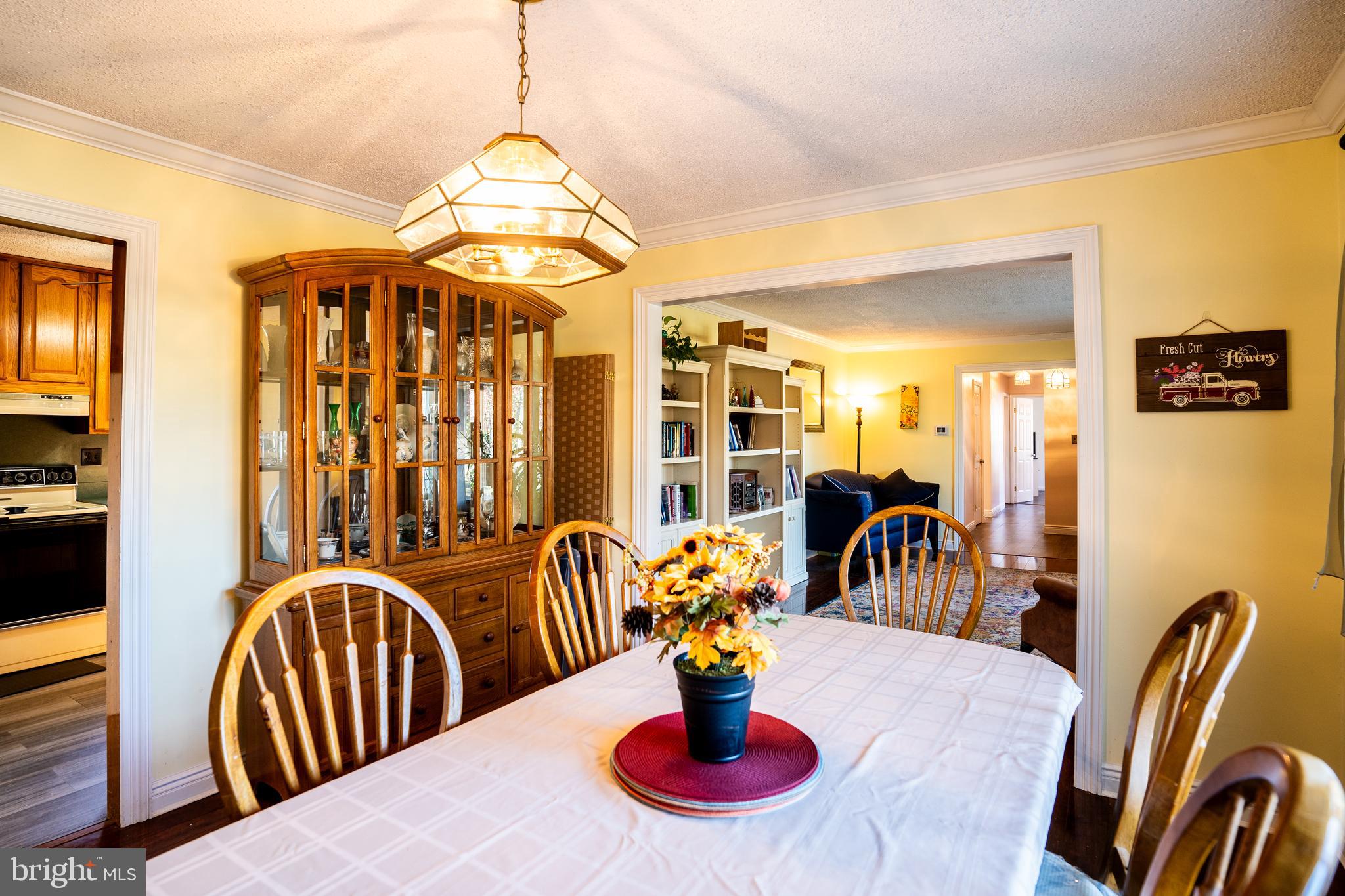 181 Edgebrook Road Robbinsville, NJ 08691 - Photo 16 of 67 a dining room with furniture a chandelier and wooden floor
