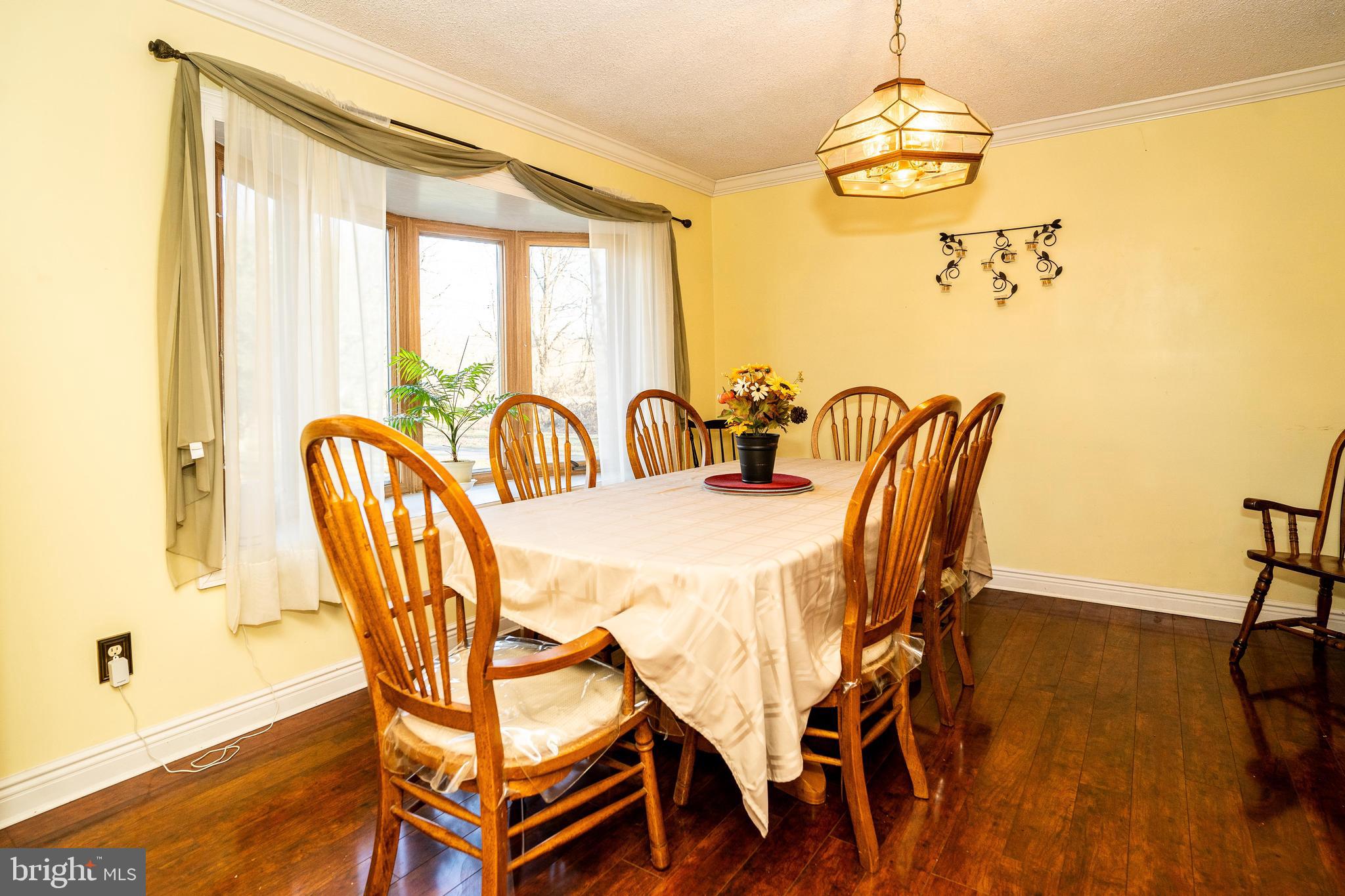 181 Edgebrook Road Robbinsville, NJ 08691 - Photo 37 of 67 a dining room with furniture a chandelier and wooden floor