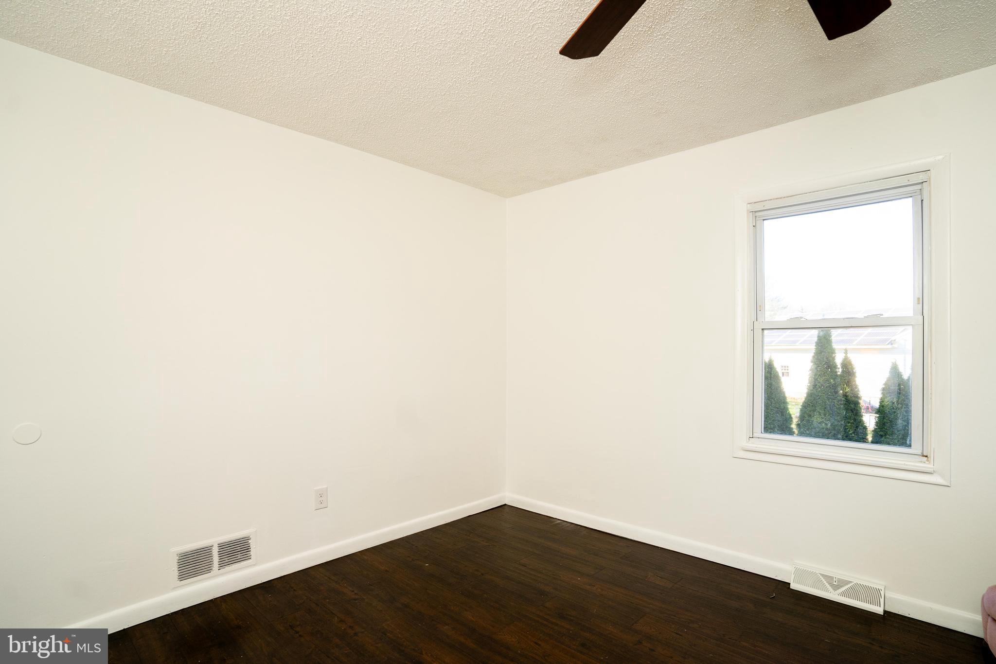 181 Edgebrook Road Robbinsville, NJ 08691 - Photo 43 of 67 an empty room with wooden floor and windows