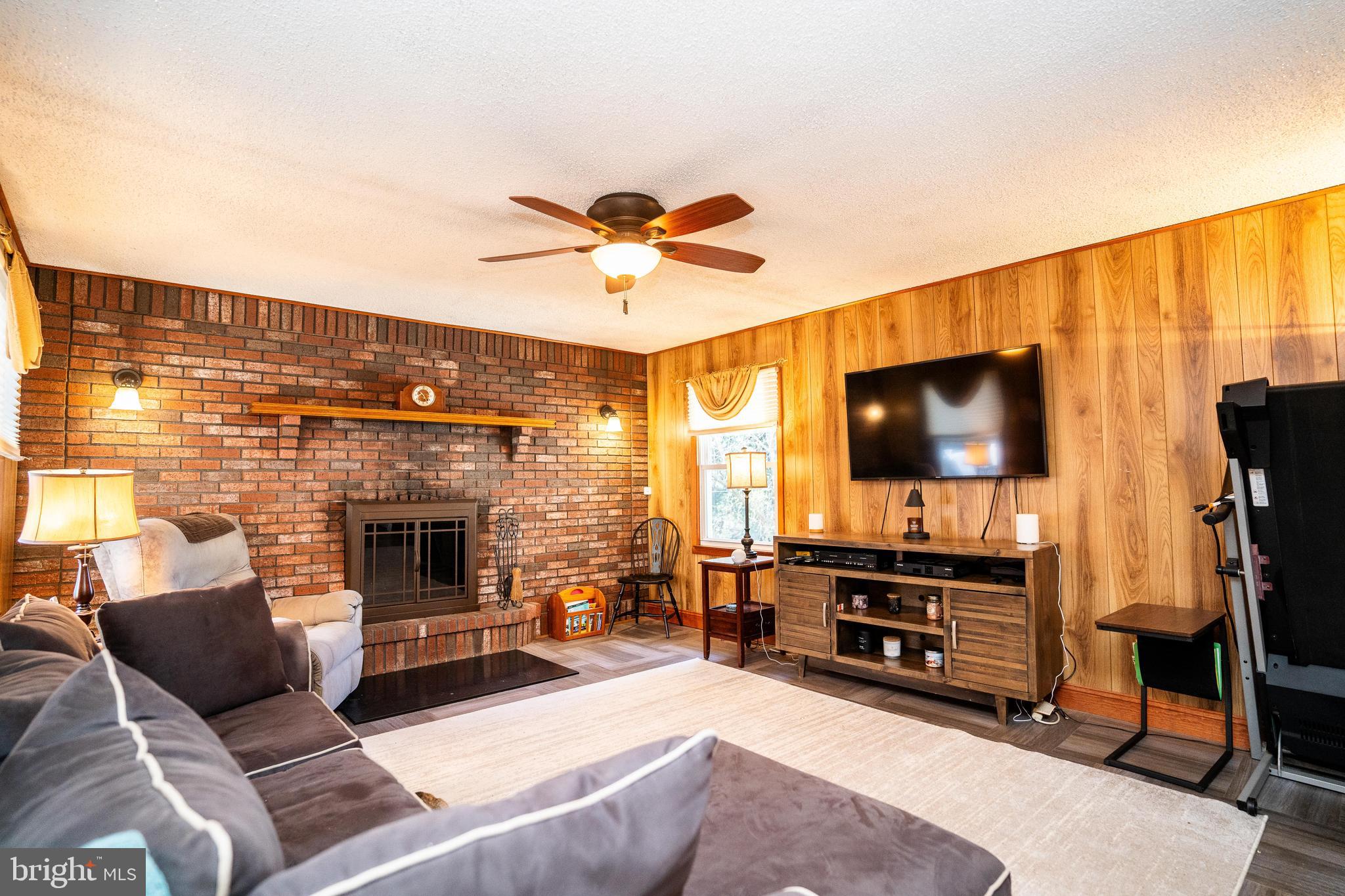 181 Edgebrook Road Robbinsville, NJ 08691 - Photo 59 of 67 a living room with furniture and a flat screen tv