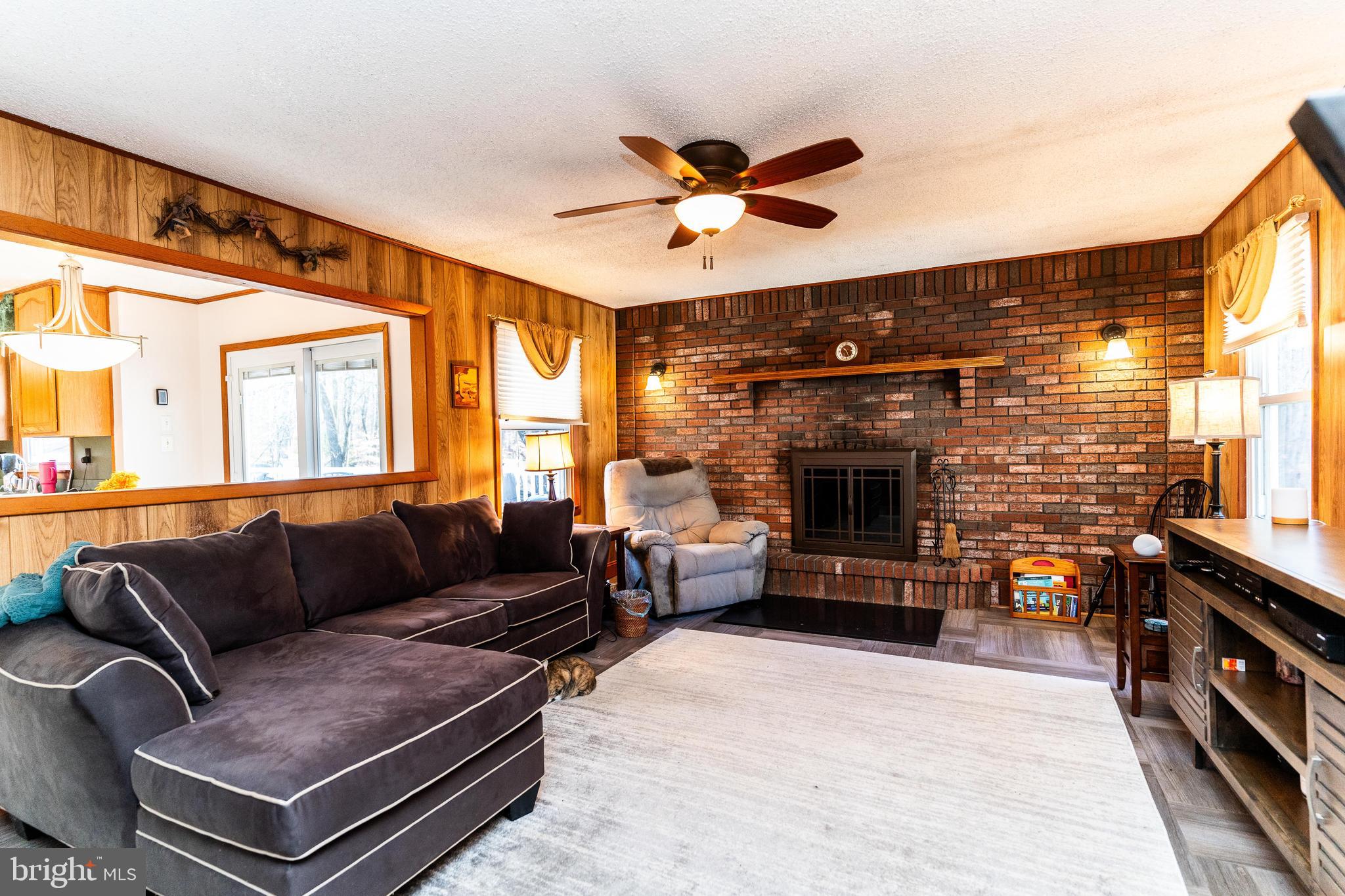 181 Edgebrook Road Robbinsville, NJ 08691 - Photo 61 of 67 a living room with furniture a fireplace and a flat screen tv