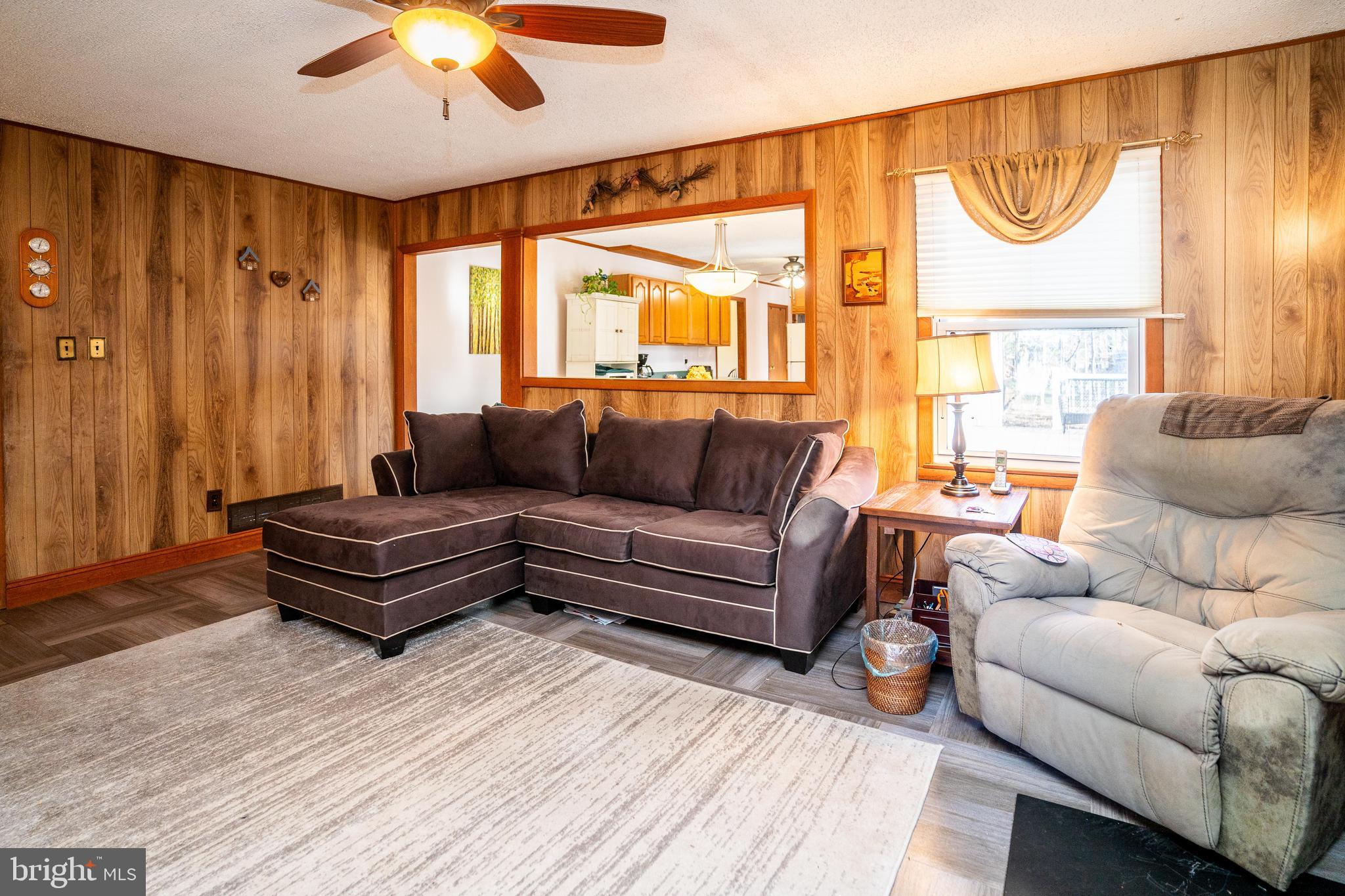 181 Edgebrook Road Robbinsville, NJ 08691 - Photo 63 of 67 a living room with furniture a flat screen tv and a large window