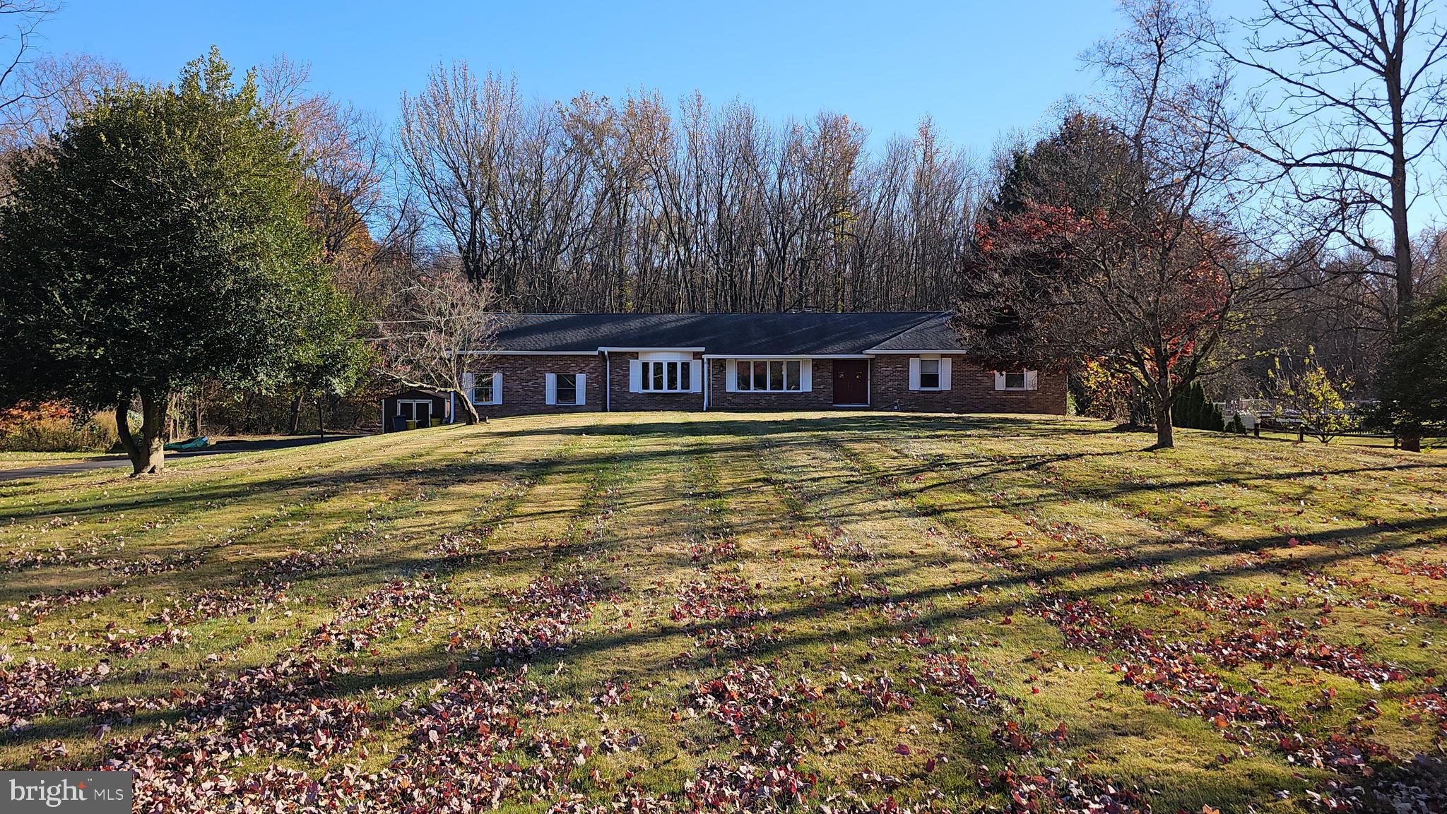 181 Edgebrook Road Robbinsville, NJ 08691 - Photo 9 of 67 a view of swimming pool with outdoor seating and trees in the background