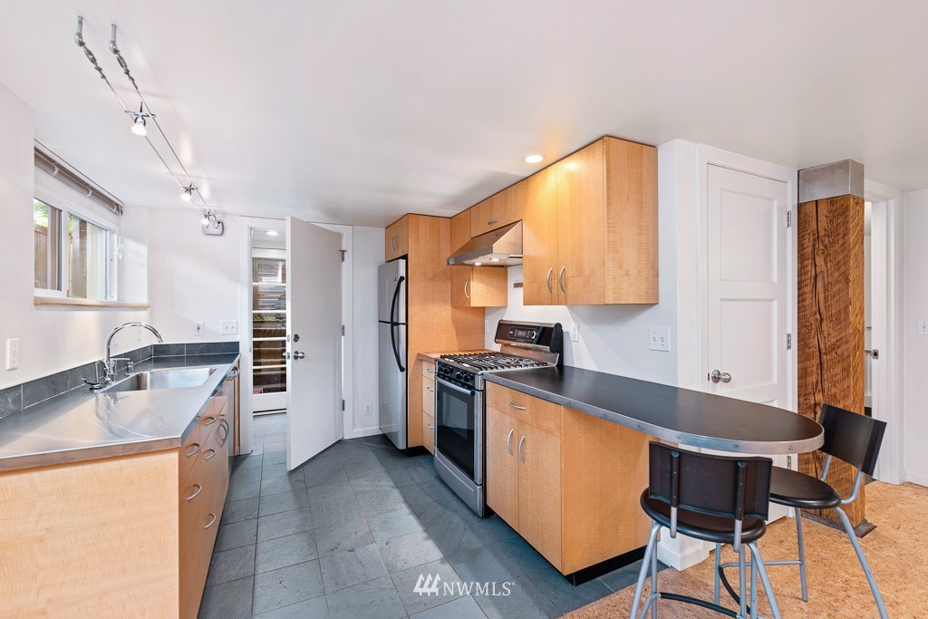 428 Northwest 45th Street Seattle, WA 98107 - Photo 12 of 26 a kitchen with granite countertop a sink stove and refrigerator