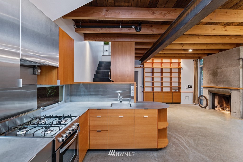 428 Northwest 45th Street Seattle, WA 98107 - Photo 19 of 26 a kitchen with stainless steel appliances granite countertop a stove a sink and a refrigerator