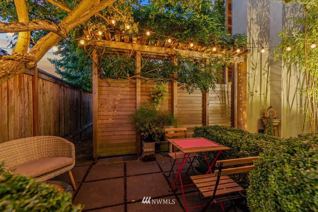 428 Northwest 45th Street Seattle, WA 98107 - Photo 4 of 26 a backyard with table and chairs and potted plants