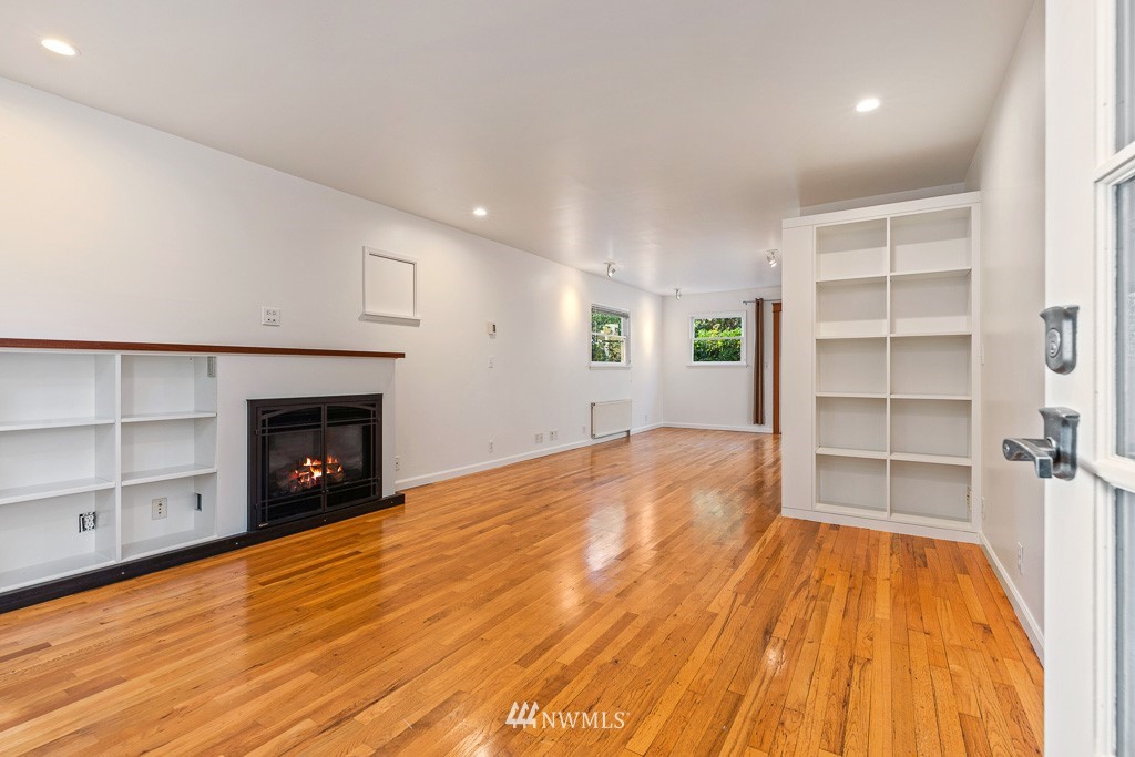 428 Northwest 45th Street Seattle, WA 98107 - Photo 7 of 26 a view of an empty room with a fireplace and a window