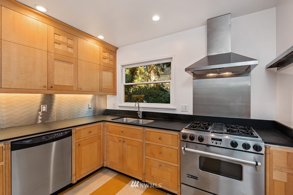 428 Northwest 45th Street Seattle, WA 98107 - Photo 8 of 26 a kitchen with granite countertop a sink stainless steel appliances and cabinets