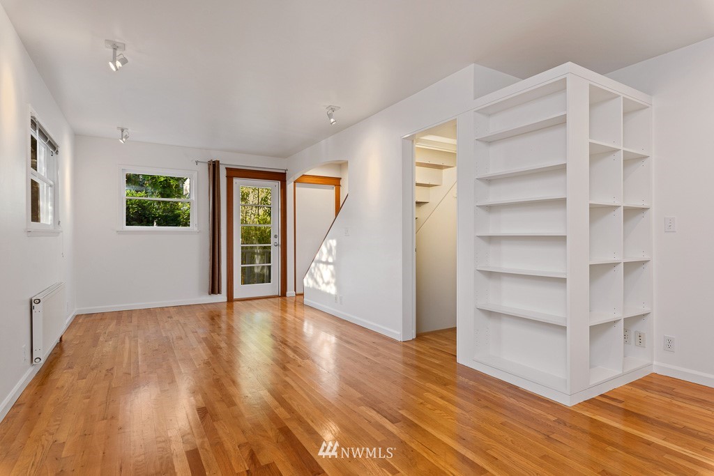 428 Northwest 45th Street Seattle, WA 98107 - Photo 9 of 26 a view of an empty room with a window and wooden floor