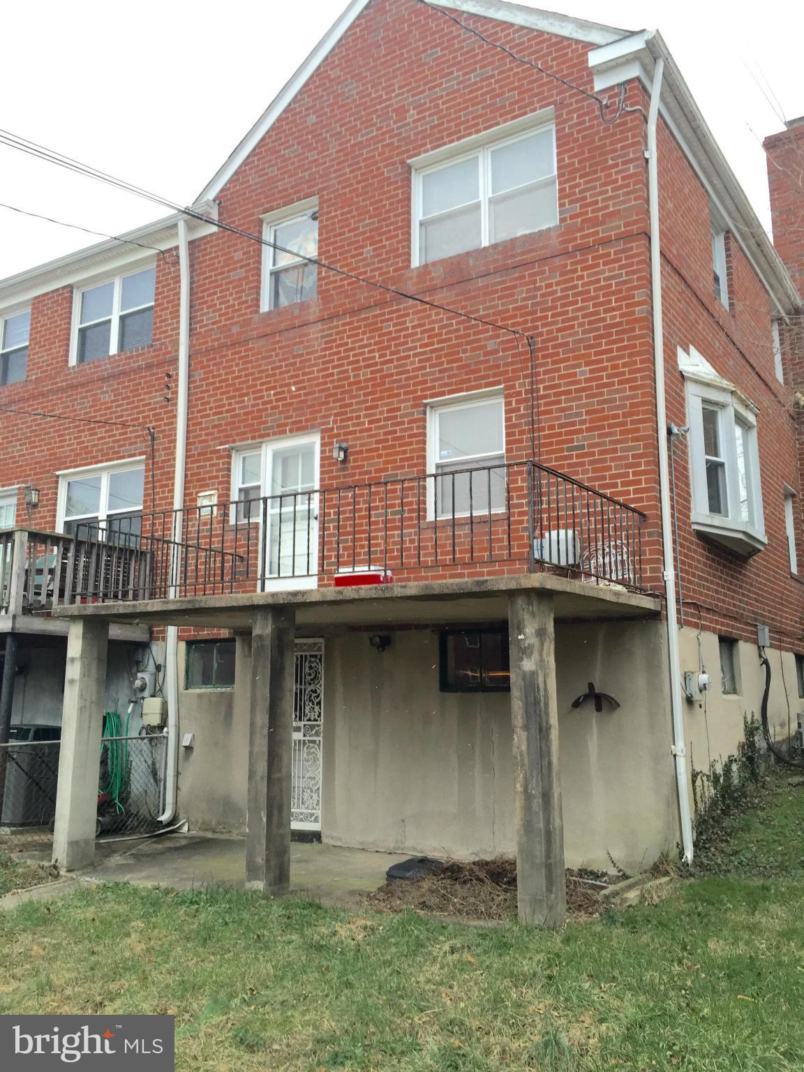980 Masefield Road Baltimore, MD 21207 - Photo 3 of 5 a front view of a residential apartment building with a yard