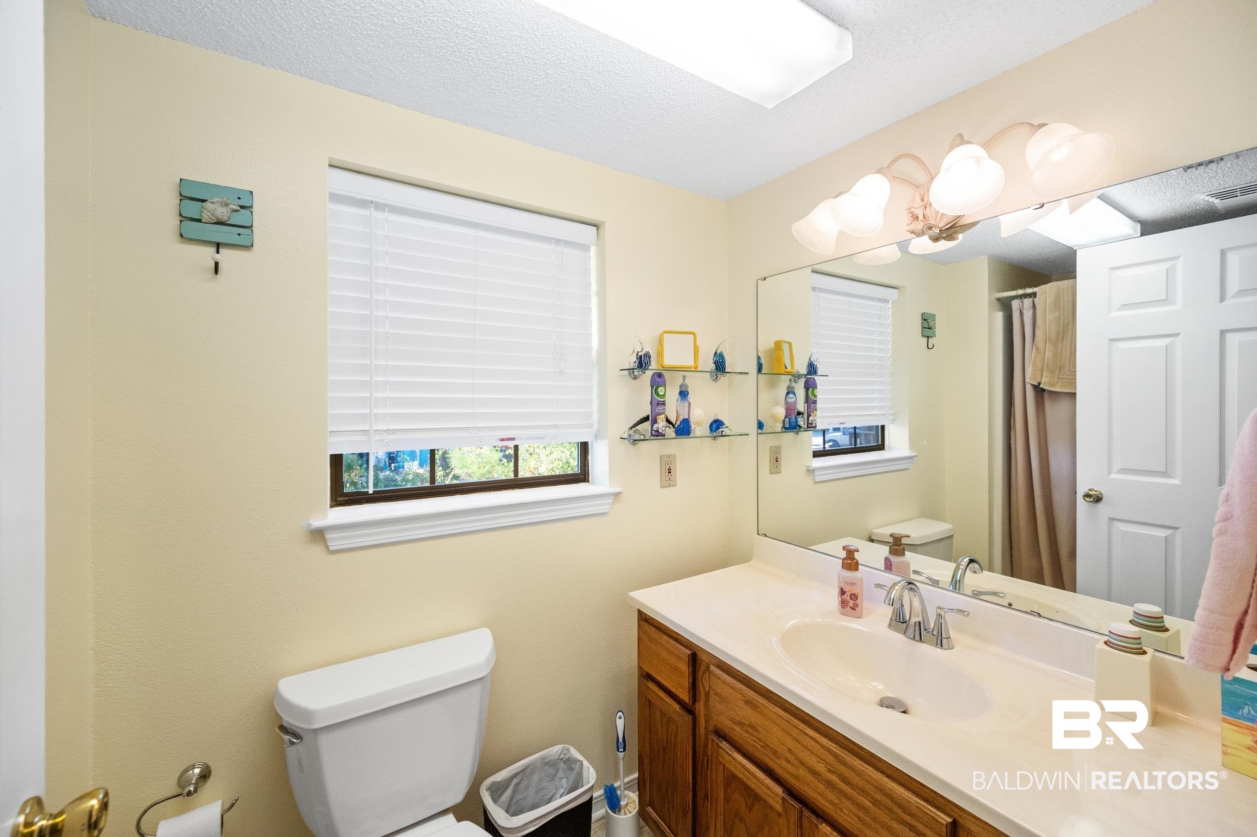 5392 Ornacor Avenue Orange Beach, AL 36561 - Photo 23 of 48 Bathroom featuring toilet, a textured ceiling, and vanity