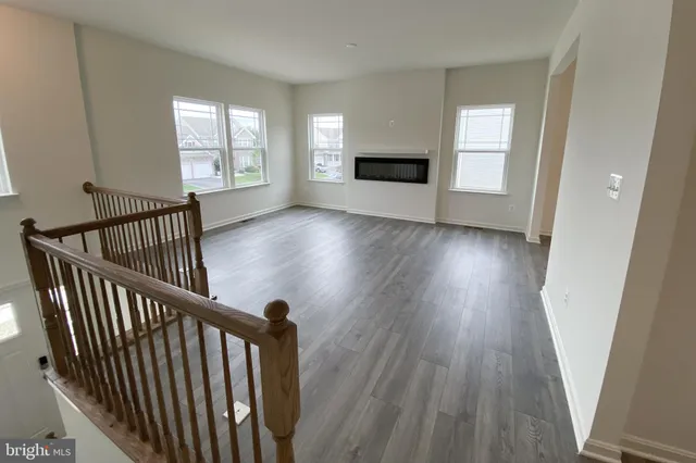 wooden floor in an empty room with a window and wooden floor